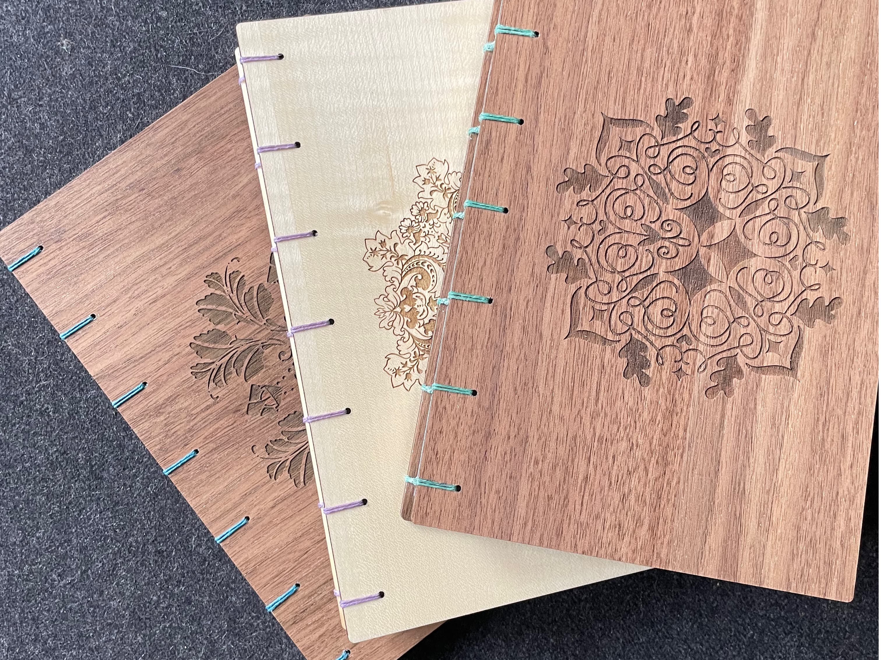 Three Fondfolio books I made recently for retiring colleagues, two with Walnut wood covers and one with Maple wood.